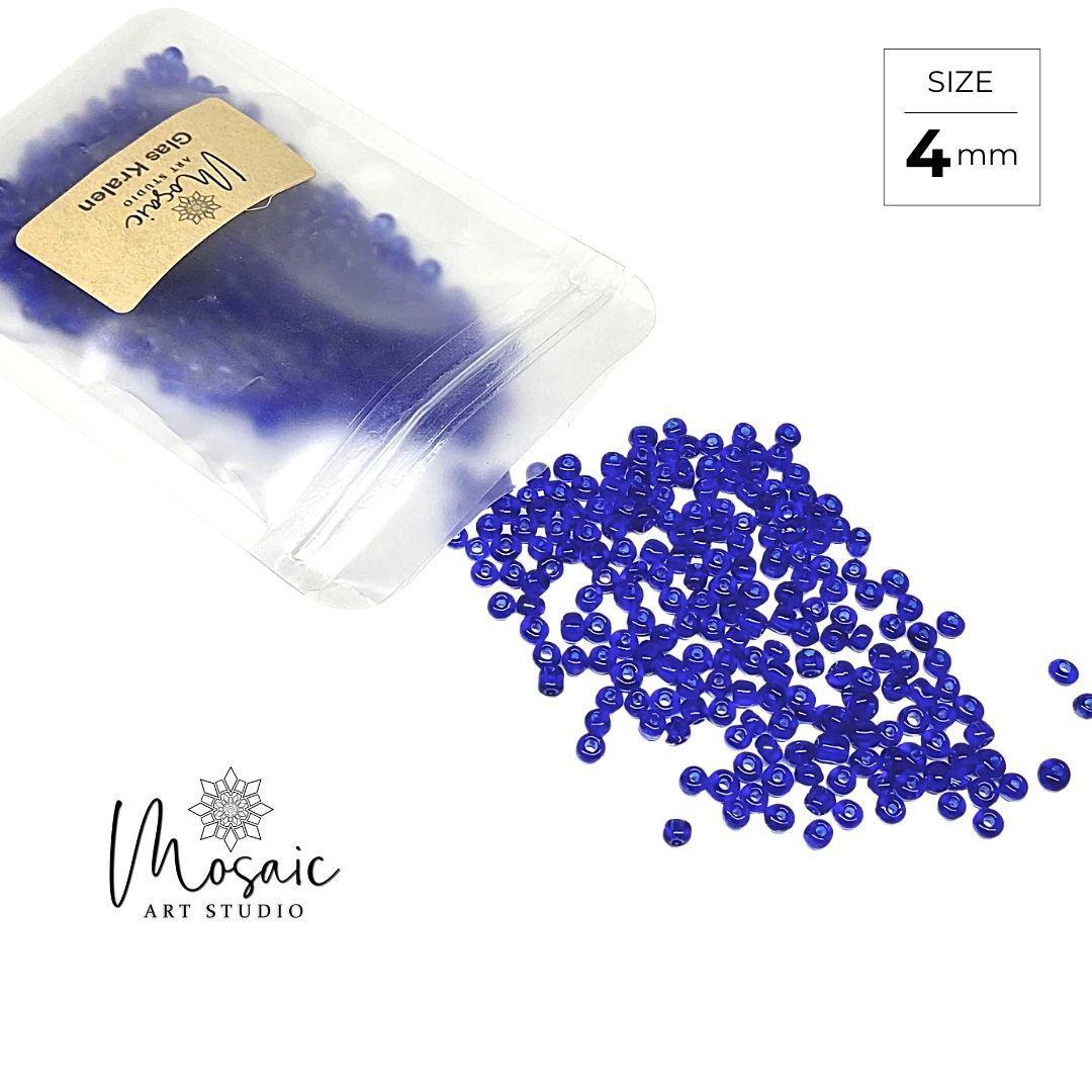 4mm blue glass beads spilling from plastic pouch for mosaic art projects